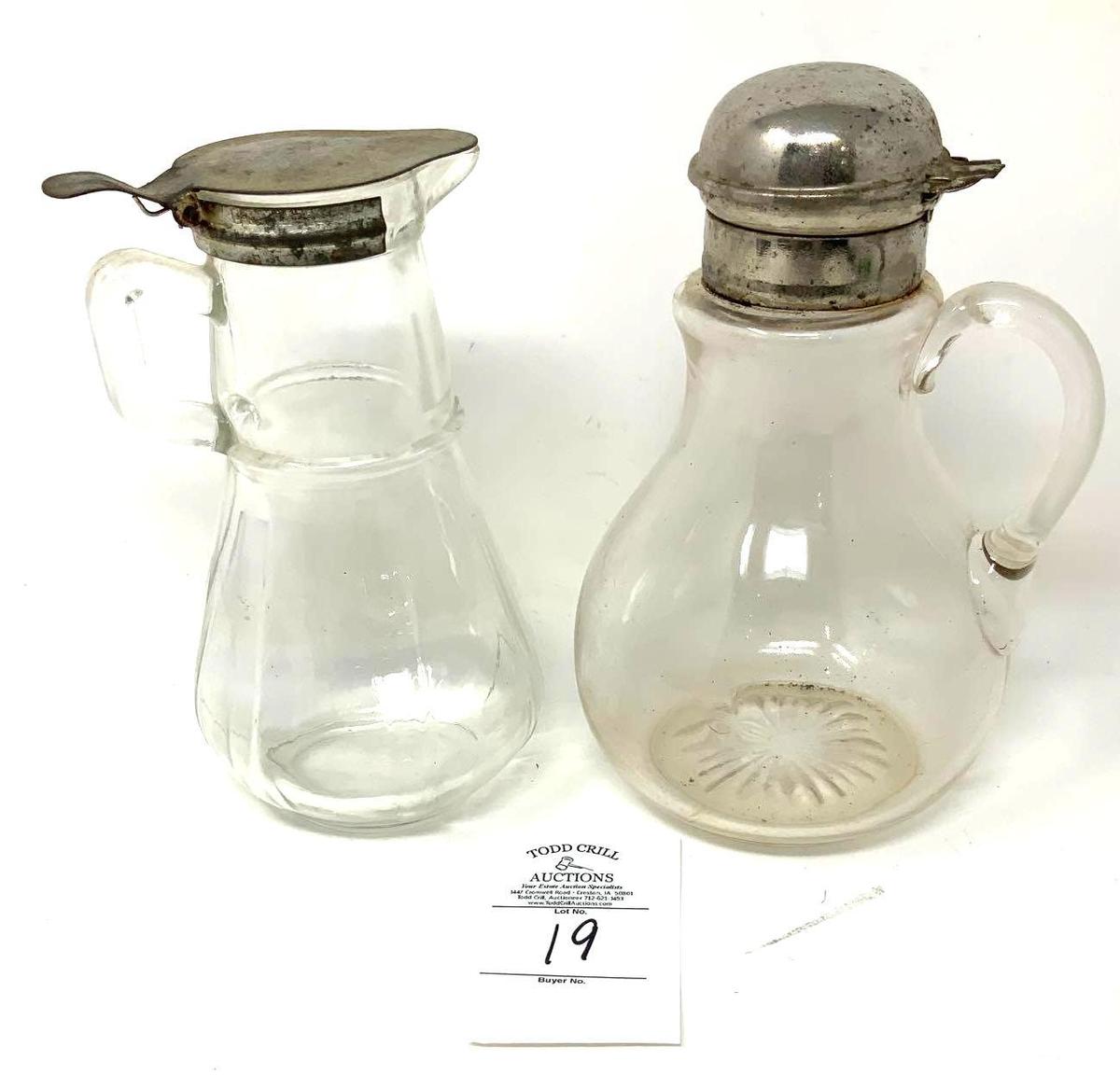 Two antique syrup dispensers