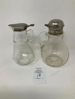 Two antique syrup dispensers