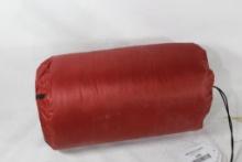 Self inflating sleeping bag ground cover in red nylon bag.