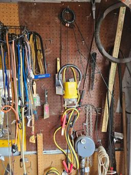 assorted tools and miscellaneous on wall