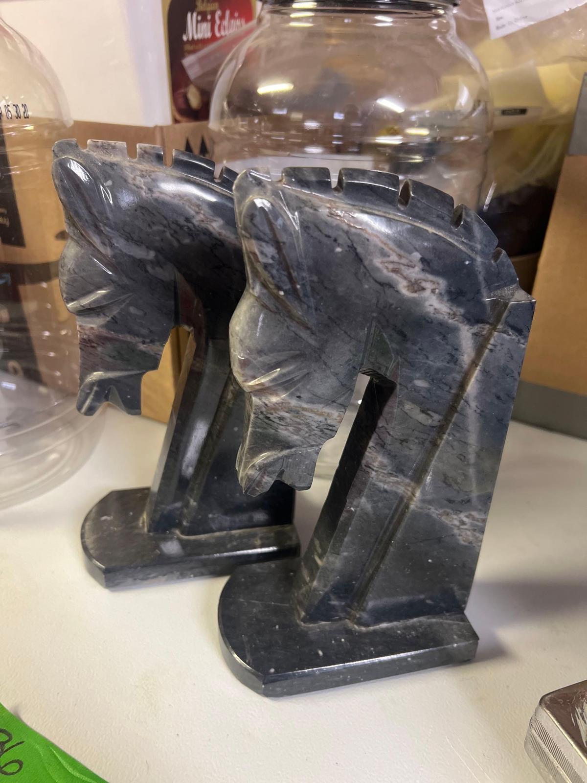 marble horse head book ends in basement