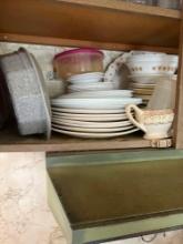 Bottom shelf of kitchen cabinet some coreal dishes and more