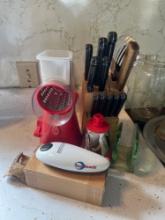 cheese grater, knives, and miscellaneous in kitchen