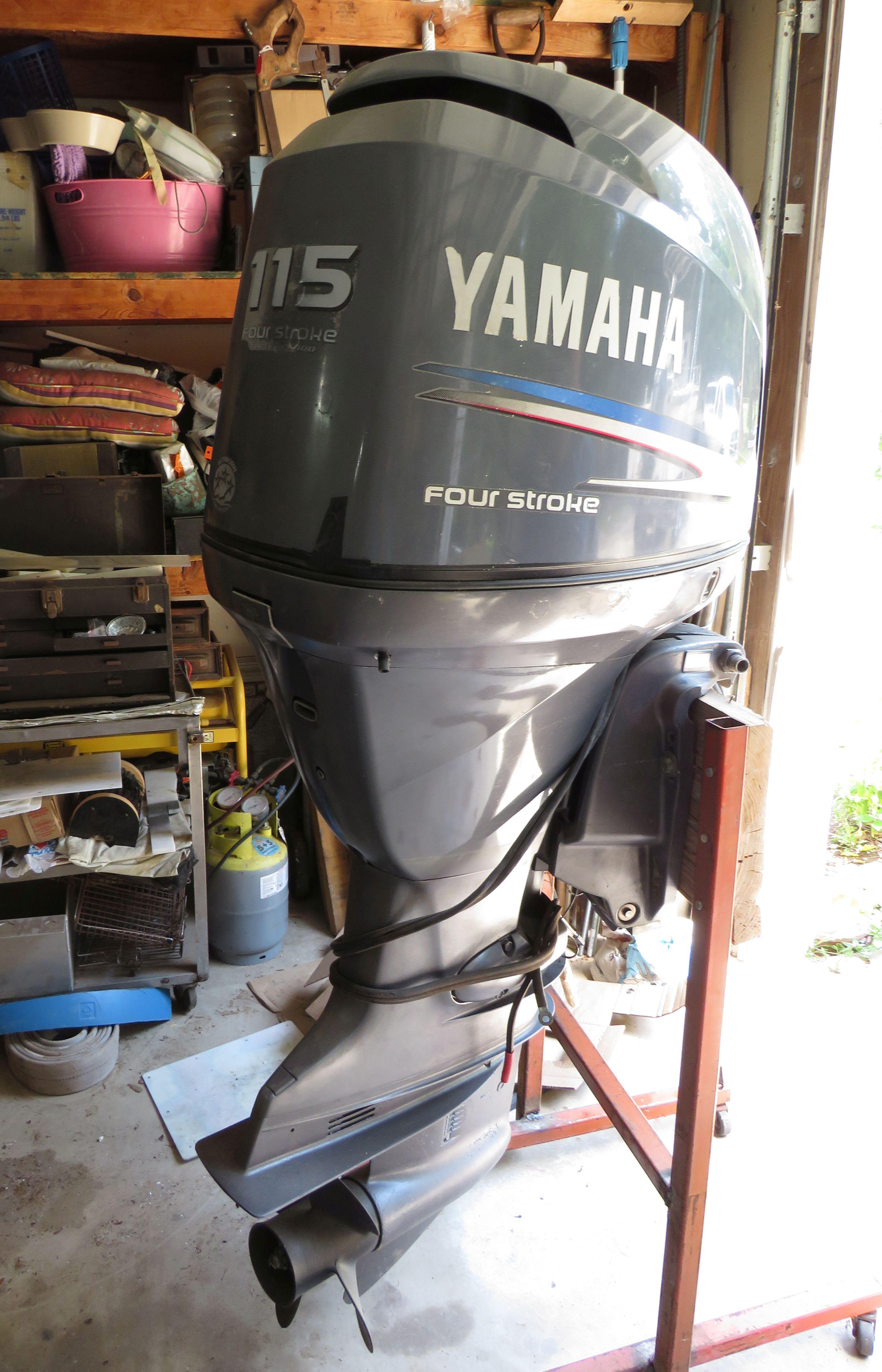 2005  115 hp Yamaha 4 stroke outboard motor with prop, controls, wire harness, and steel stand,  ...