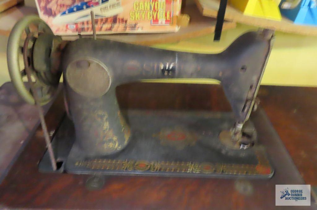Singer antique throttle sewing machine in basement