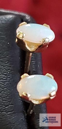 Opal like gemstone and gold colored earrings, marked 14K, total approximate weight is .33 G
