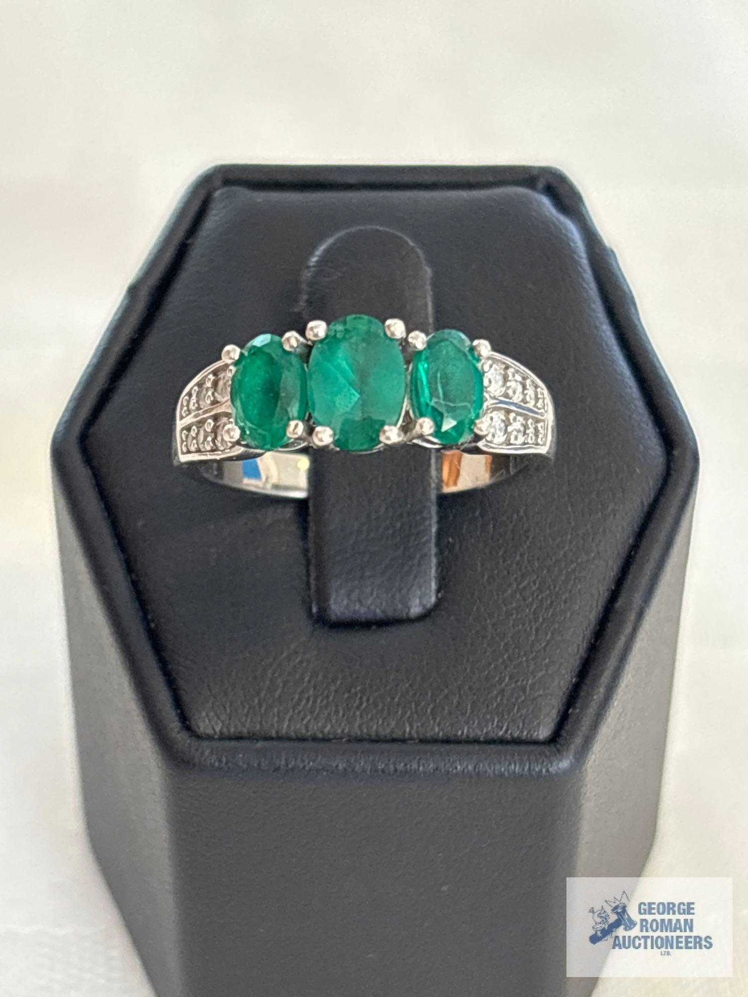 Silver colored ring with three green gemstones and clear gemstones, marked 925, approximate total