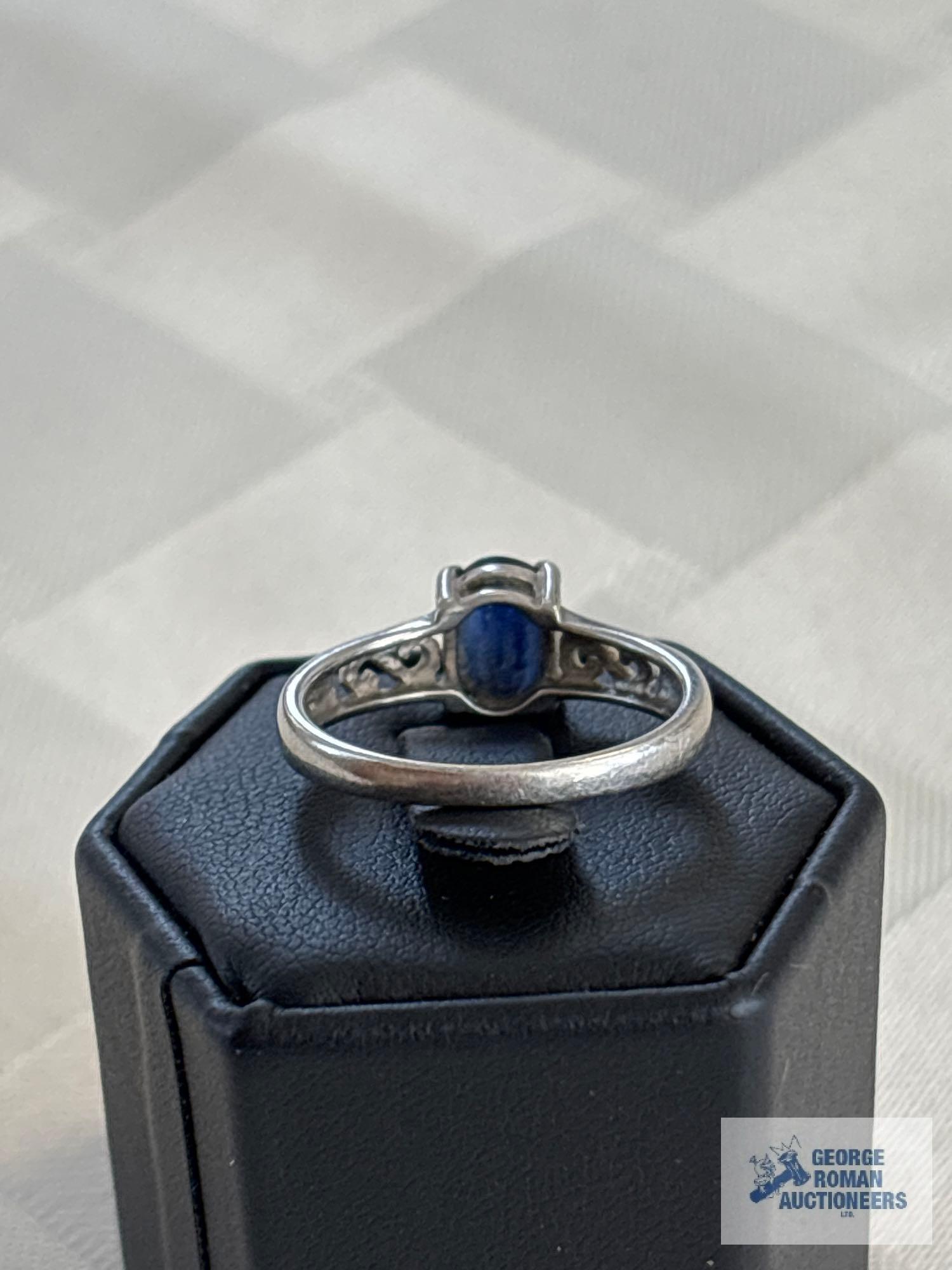 Silver colored ring with blue stone, marked 925, approximate total weight is 2.41 G