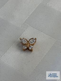 Gold colored butterfly pendant with clear gemstones, marked 925, approximate total weight is 1.26 G