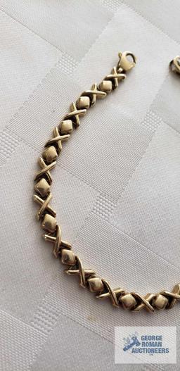 Gold colored X's and O's bracelet,...marked 14KT Italy, approximate total weight is 7.16 G