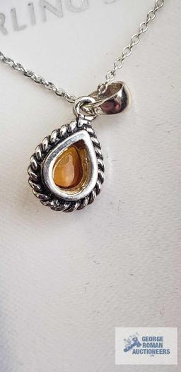 Amber colored stone teardrop shaped pendant on silver colored chain, chain marked 925 Italy