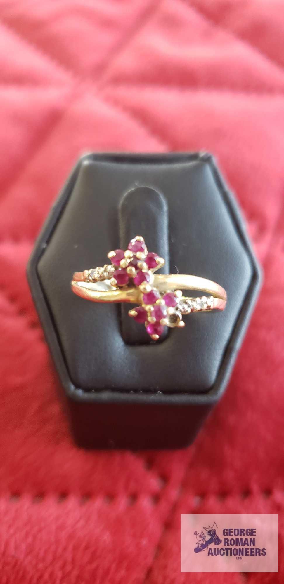 Gold...colored ring with red floral gemstones and clear gemstones on band, marked 14K, missing one r