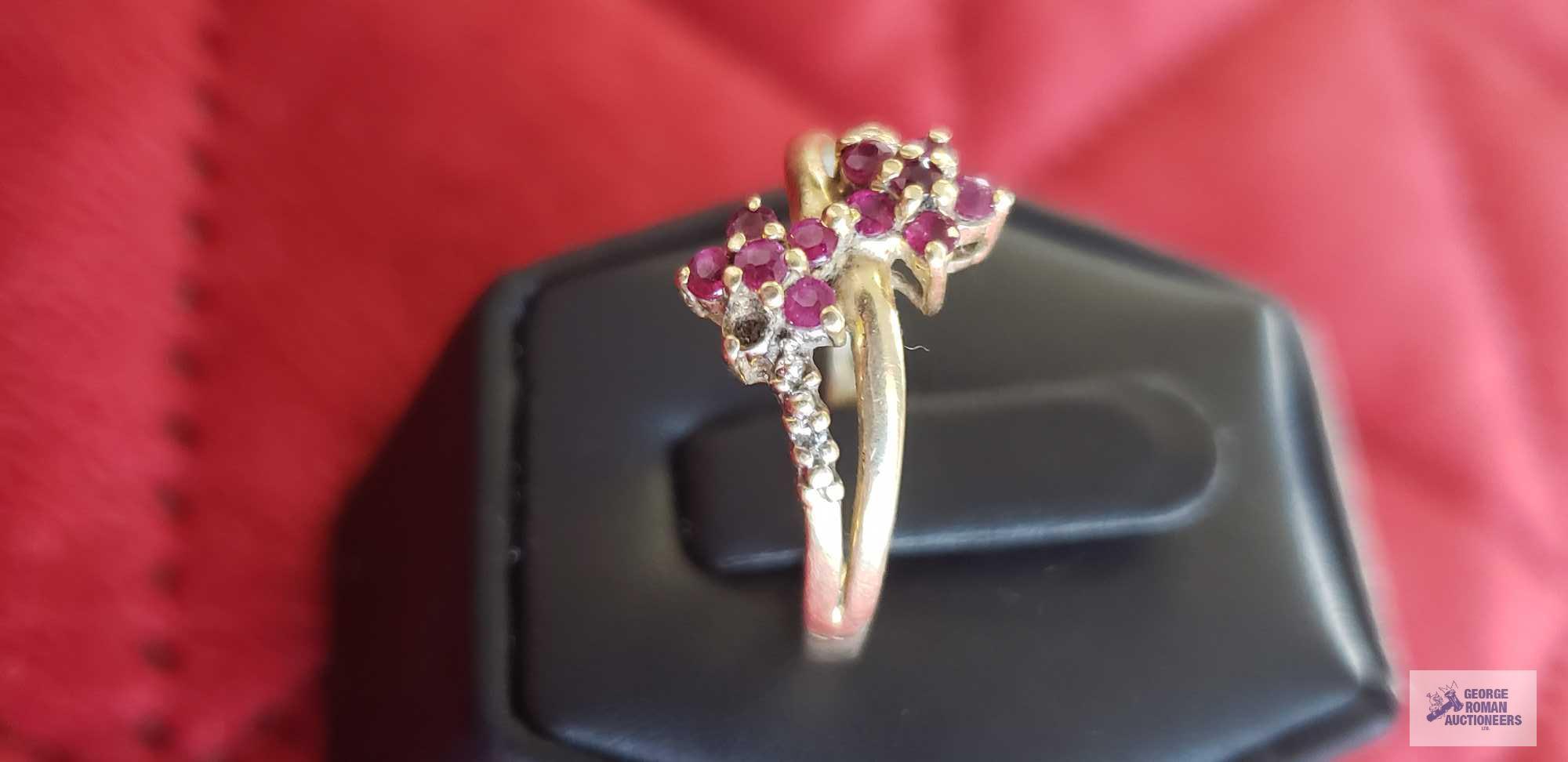 Gold...colored ring with red floral gemstones and clear gemstones on band, marked 14K, missing one r