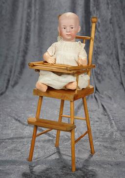 10" German bisque character, 7602, by Gebruder Heubach in high chair. $300/500
