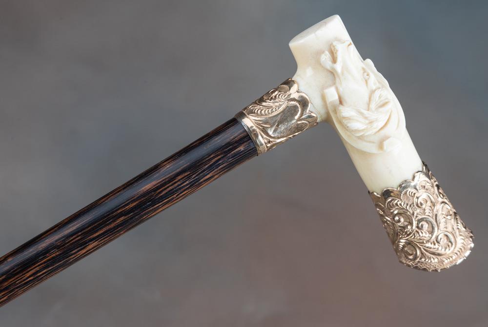 High quality, vintage ivory handled Cane with carved horsehead inside of horseshoe, trimmed in heavi