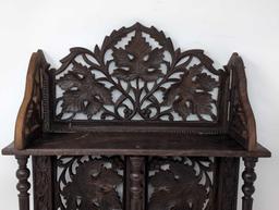(LR) ANTIQUE ORNATE CARVED WOOD INDIAN FOLDING WALL SHELF WITH LEAF AND FLORAL DETAILING. IT
