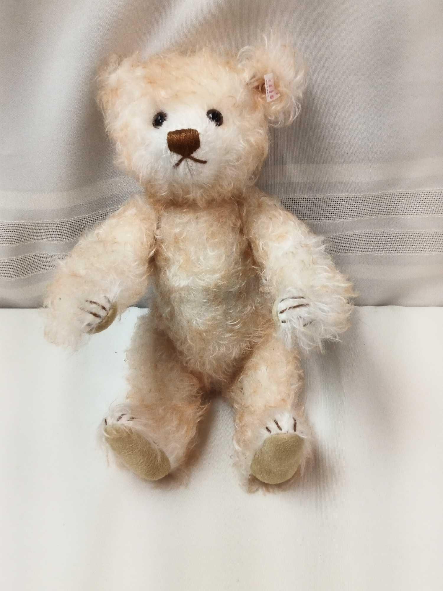 STIEFF BEAR. BUFF COLOR 12" DRESSED IN HOLLAND STYLE DRESS, CAP, AND WOODEN SHOES