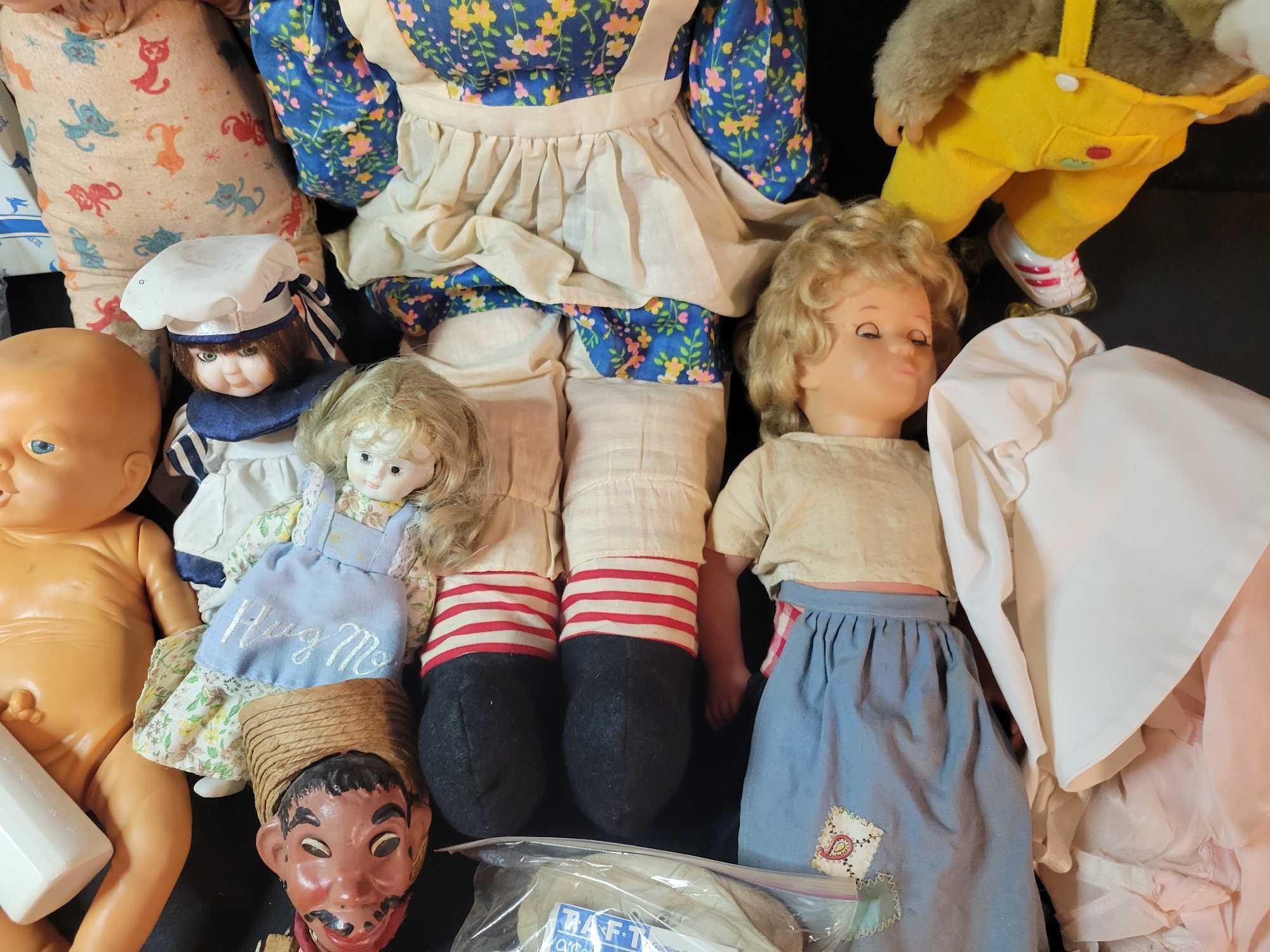 Assorted vintage baby dolls, puppets, kewpie dolls, clothing