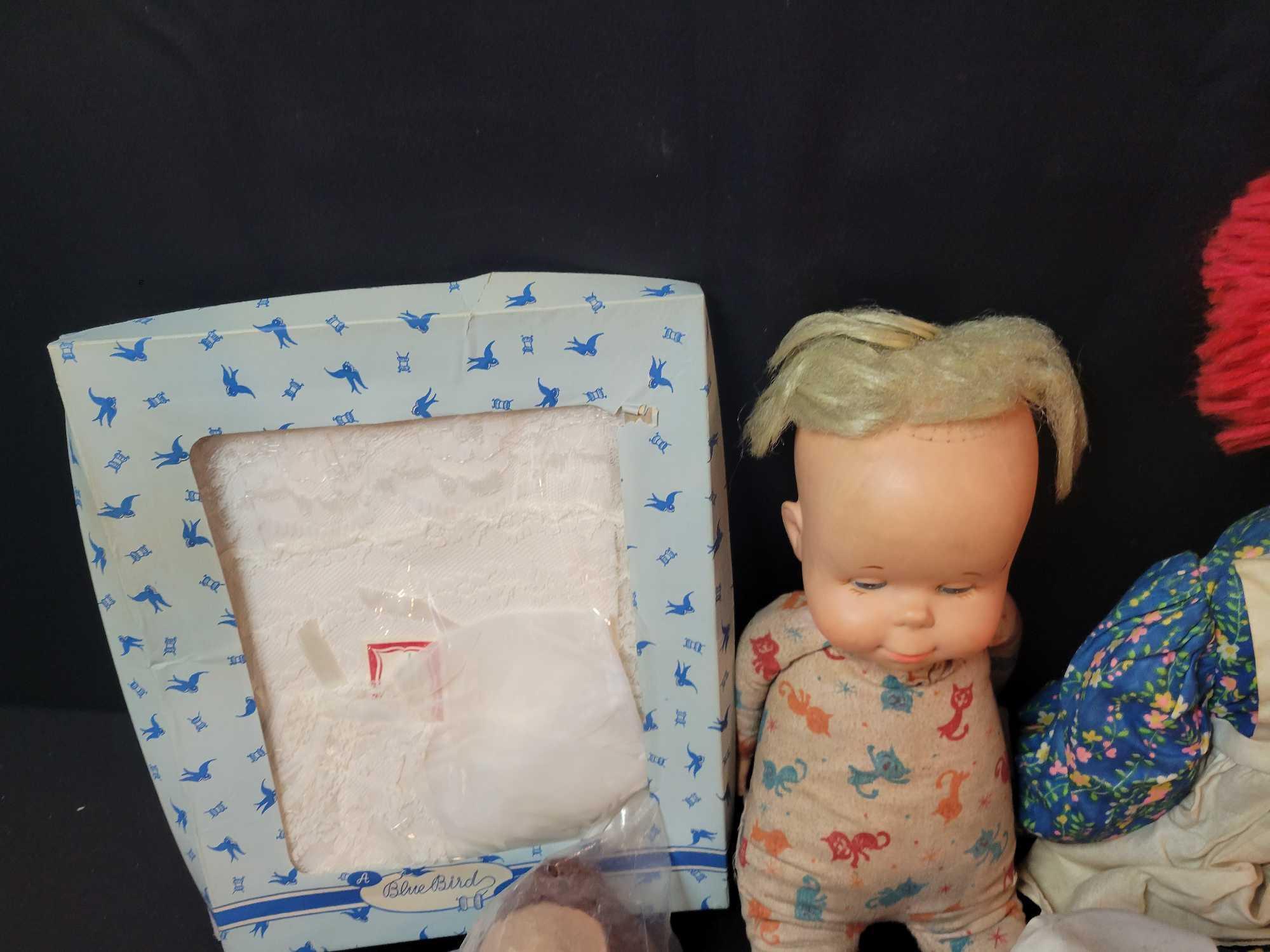 Assorted vintage baby dolls, puppets, kewpie dolls, clothing