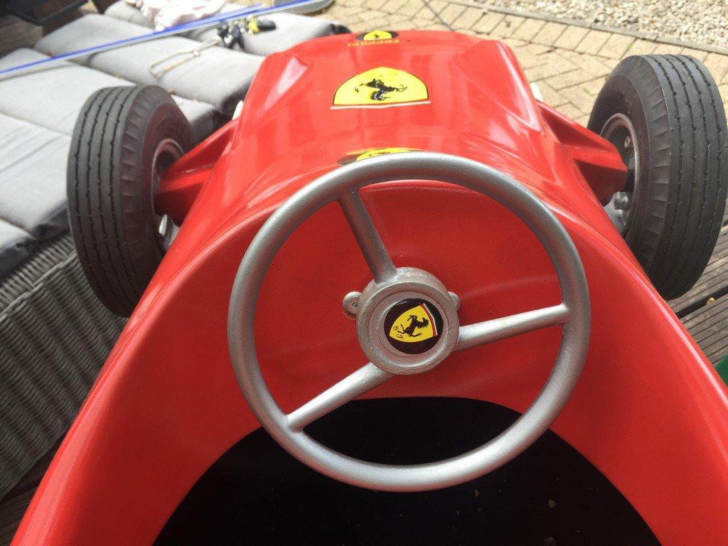 Child's arcade ride in the form of a 60's Ferrari