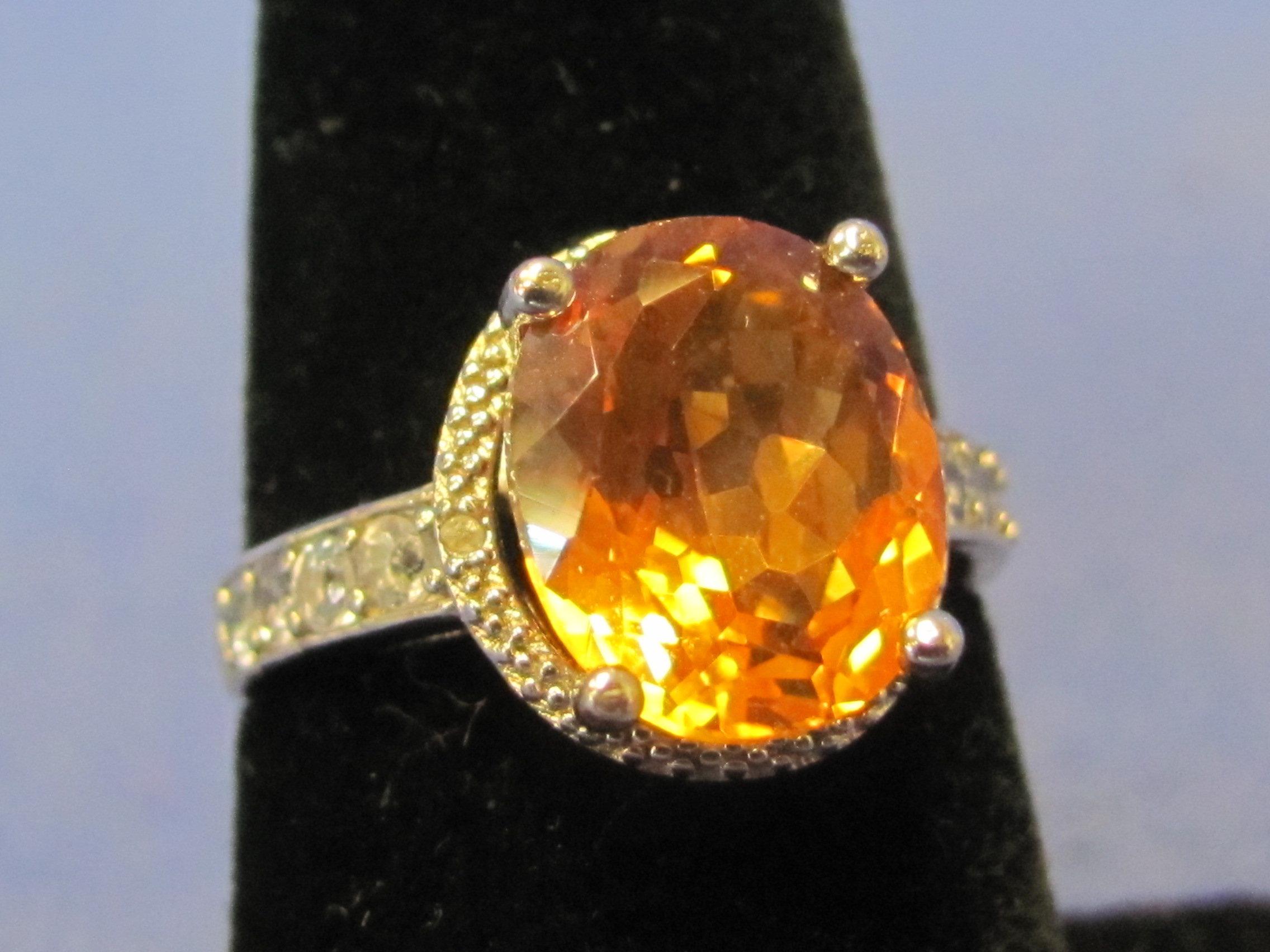 Sterling Silver Ring – Orange Oval Stone – 8 Small Tanzanite – Size 7 – Weight is 3.5 grams – New w