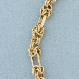 Italian Designer Knot And Oval Link Chain Bracelet In 14k Yellow Gold
