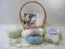 Assorted Skeins of White, Blue and Yellow Yarn with Several Patterns in a Basket, Basket Included