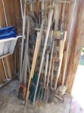 Group of Hand Tools in Front of Shed, Large Group with Axes, Shovels and Ra