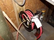 Air Hose Reel Mounted on Wall Next to Air Compressor