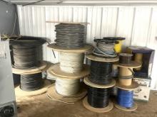 LOT WITH APPROX. (12) SPOOLS OF CABLE AND WIRE ON TOP OF SMALL SHOP