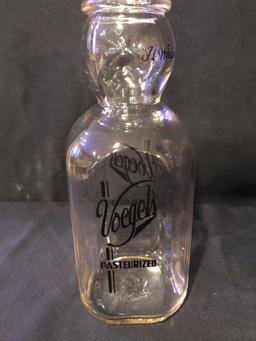 Voegel's antique milk bottle, with face.
