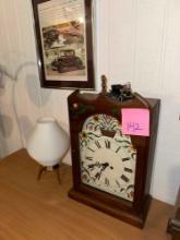 Antique clock, framed auto advertisement, lamp