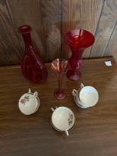 Desk lamp, cups and ruby red vases.