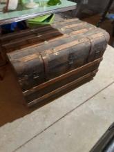 Square trunk with wood slats.