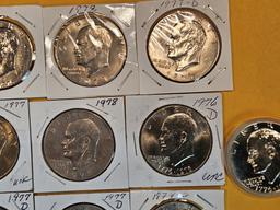 Thirteen mixed Eisenhower Dollars