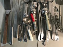 Large assortment of serving ladles and spoons