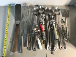 Large assortment of serving ladles and spoons
