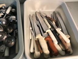 Large assortment of serving utensils, and knives, with bus tote