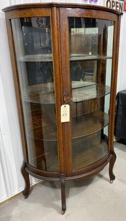 Antique curved glass curio cabinet on casters