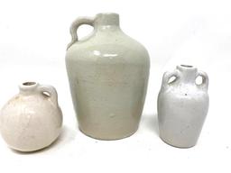 Three white antique crock jugs