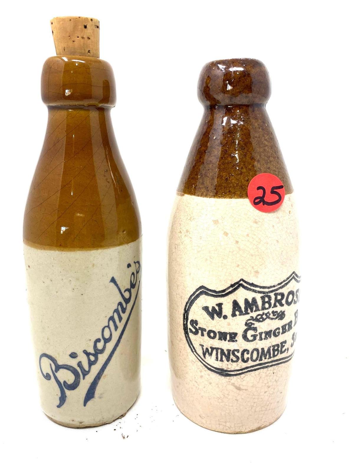 Two brown and white crock bottles, W. Ambrose ginger beer