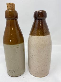 Two brown and white crock bottles, W. Ambrose ginger beer