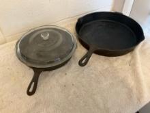 unmarked #10 cast iron skillet w/glass lid & unmarked #14 cast iron skillet