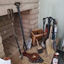 Lot of fireplace tools/utensils bellow shovels poker brushes etc. @ farm