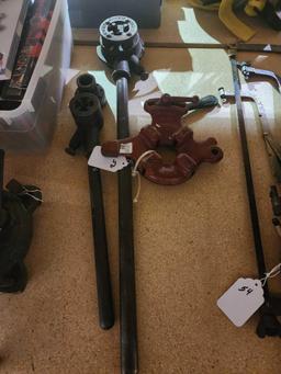 Two pipe threaders and one pipe vise. Used.