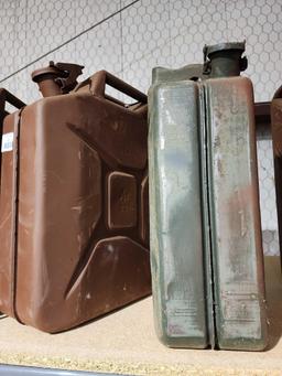 Two metal GI 5 gal gas cans. No spouts. In good condition.