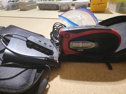 Coleman Outrider portable AM/FM radio with hand crank and power supply cable in nylon case and a Rio
