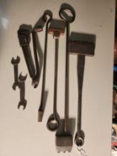 Four branding letter irons and a bag of Ford tools. Used.
