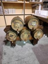 Five wooden Bavarian style 5 gal beer barrels with stand on wheels. Two racks, one holds three