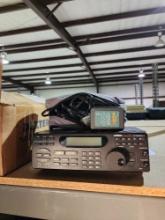 UNIDEN Bearcat 8500 police scanner and a 12 volt battery charger.